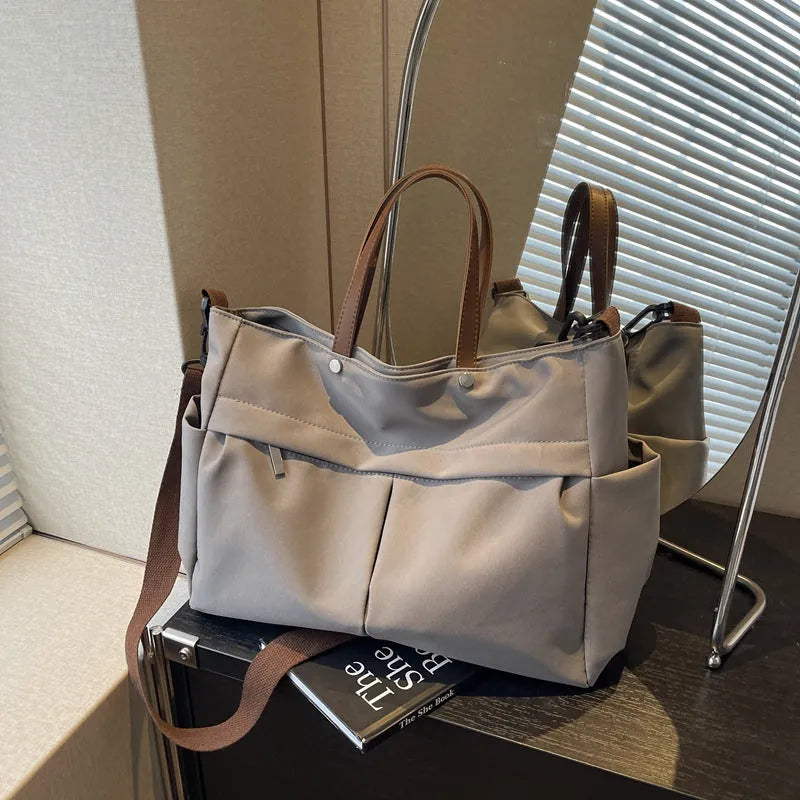 Nylon crossbody tote bag in black grey white green colours showing dimensions 39x28cm