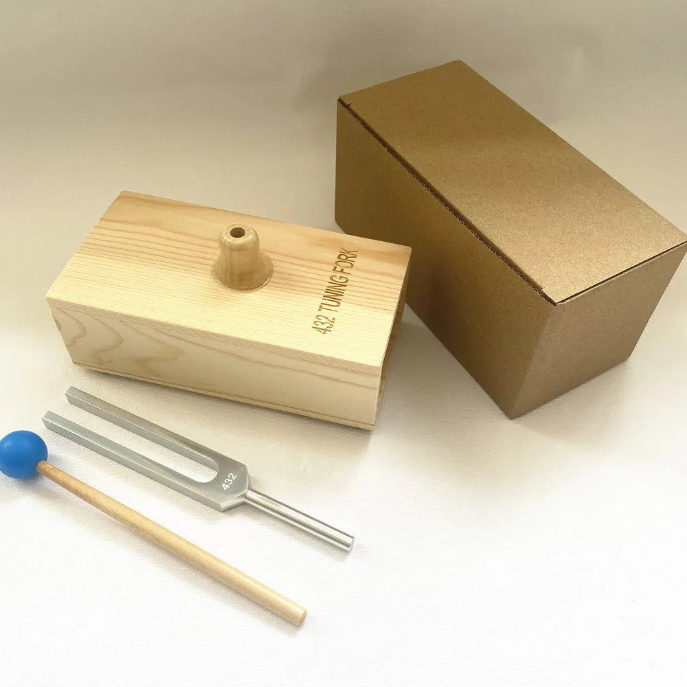 Aluminium alloy 432Hz tuning fork and speaker set on a kraft paper box.