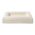 Rectangular beige cloth dog bed with raised sofa-style edges in four available sizes
