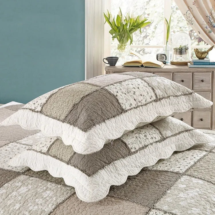 Washed pure cotton quilted bedspread and pillowcases in a beige colour, showing textured fabric.