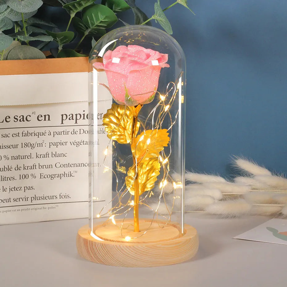Handmade eternal red rose flower with warm white LED lights inside a clear glass dome display