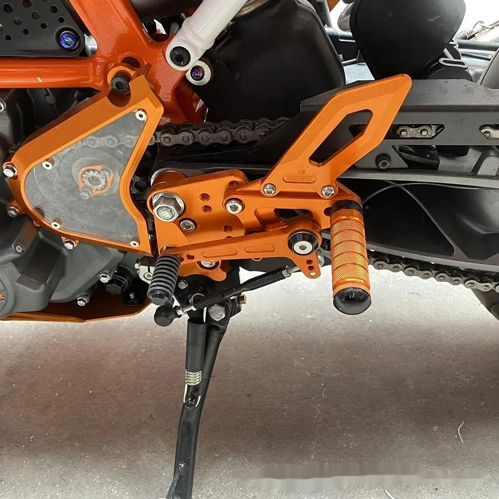 KTM Duke motorcycle black and orange foot pedal support assembly modification kit
