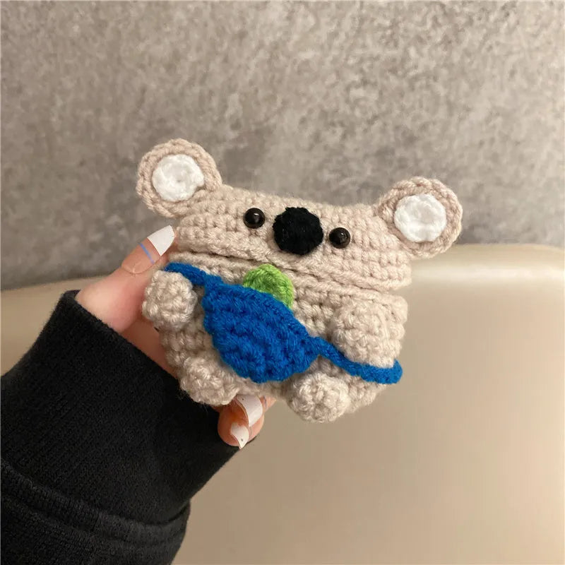 Hand-knitted grey koala bear design cover on a white Airpods case.