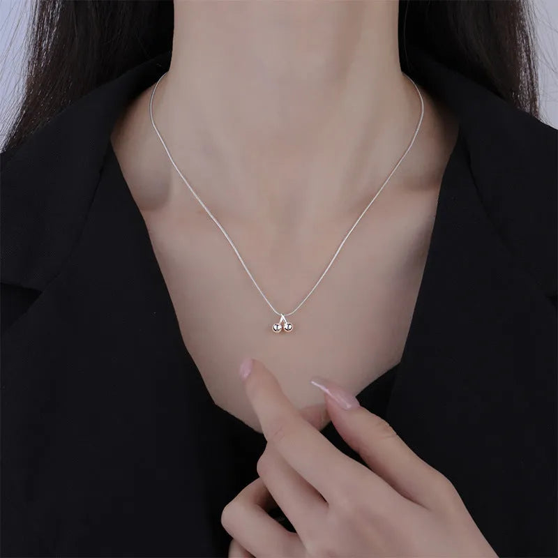 Silver cherry pendant necklace on a snake bones chain, adjustable from 21cm to 50cm length.