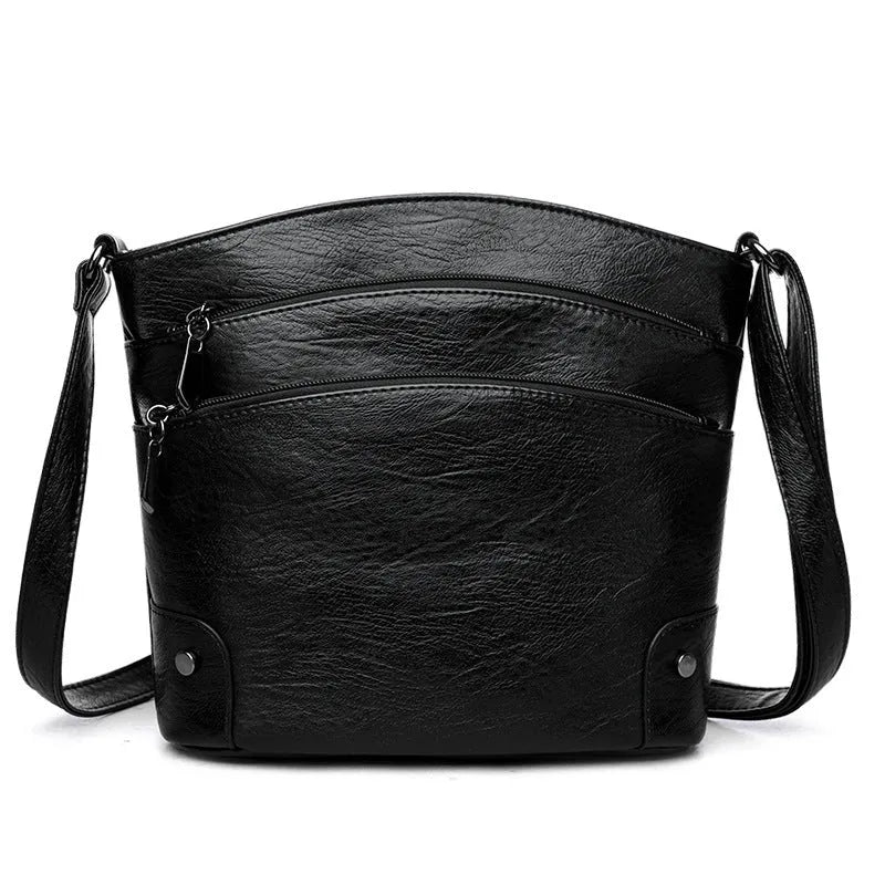 Large capacity PU bucket bag for women in black with multi-layer internal pockets and outer slit pocket
