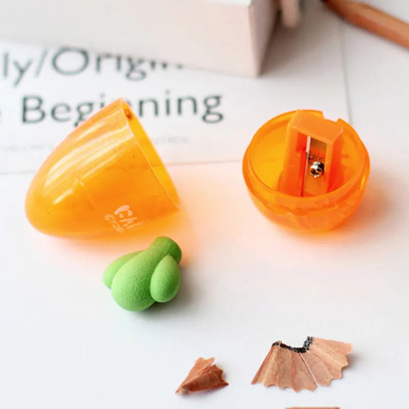 Orange carrot-shaped plastic pencil sharpener on a white background.