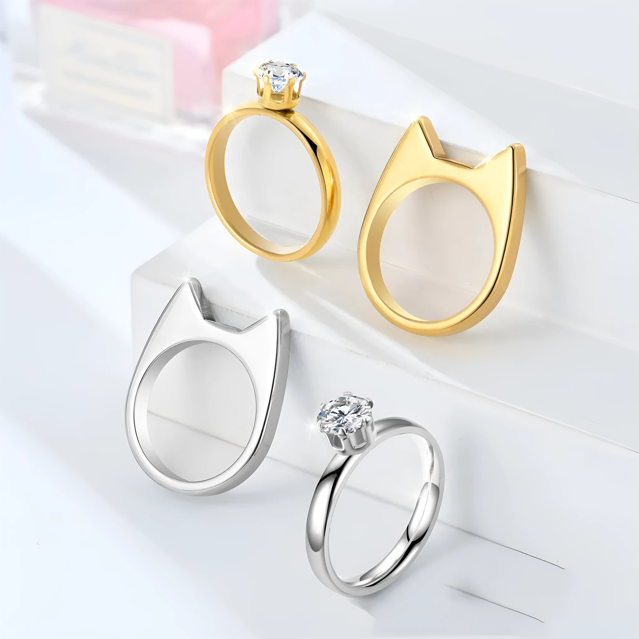 Polished stainless steel cat ear ring in gold finish, side view on white background, size No9