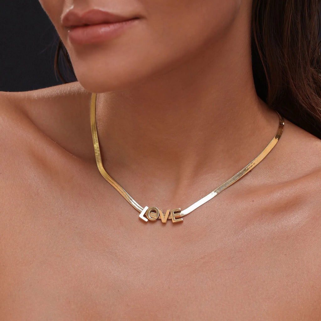 Gold and silver titanium steel necklaces with letter, number, and heart charms on a 40.5cm chain.
