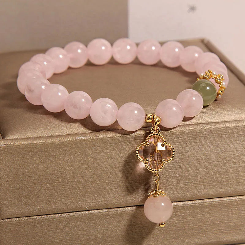 Pink crystal women's bracelet with four-leaf clover pendant and rhinestone details