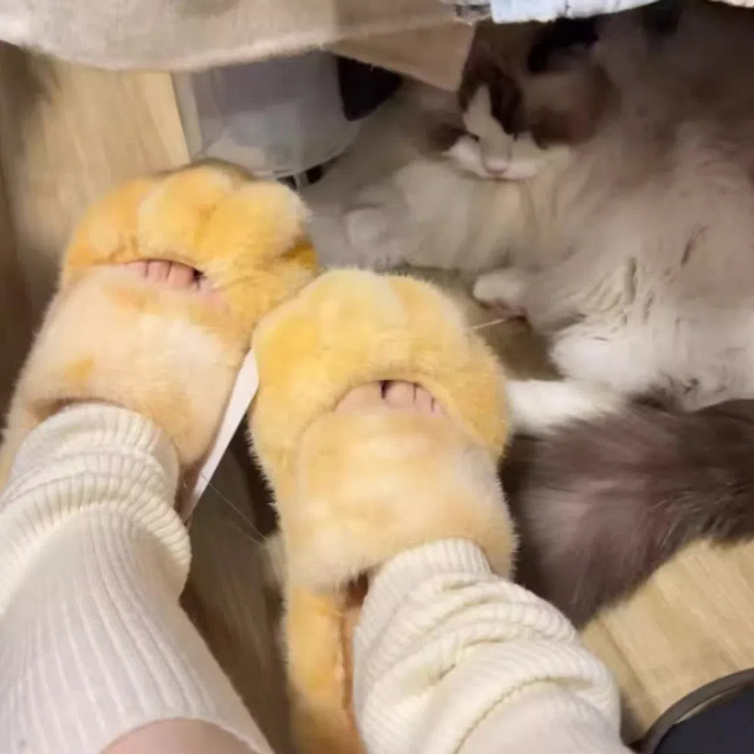 Cat paw fleece-lined slippers in yellow with non-slip sole on a floor
