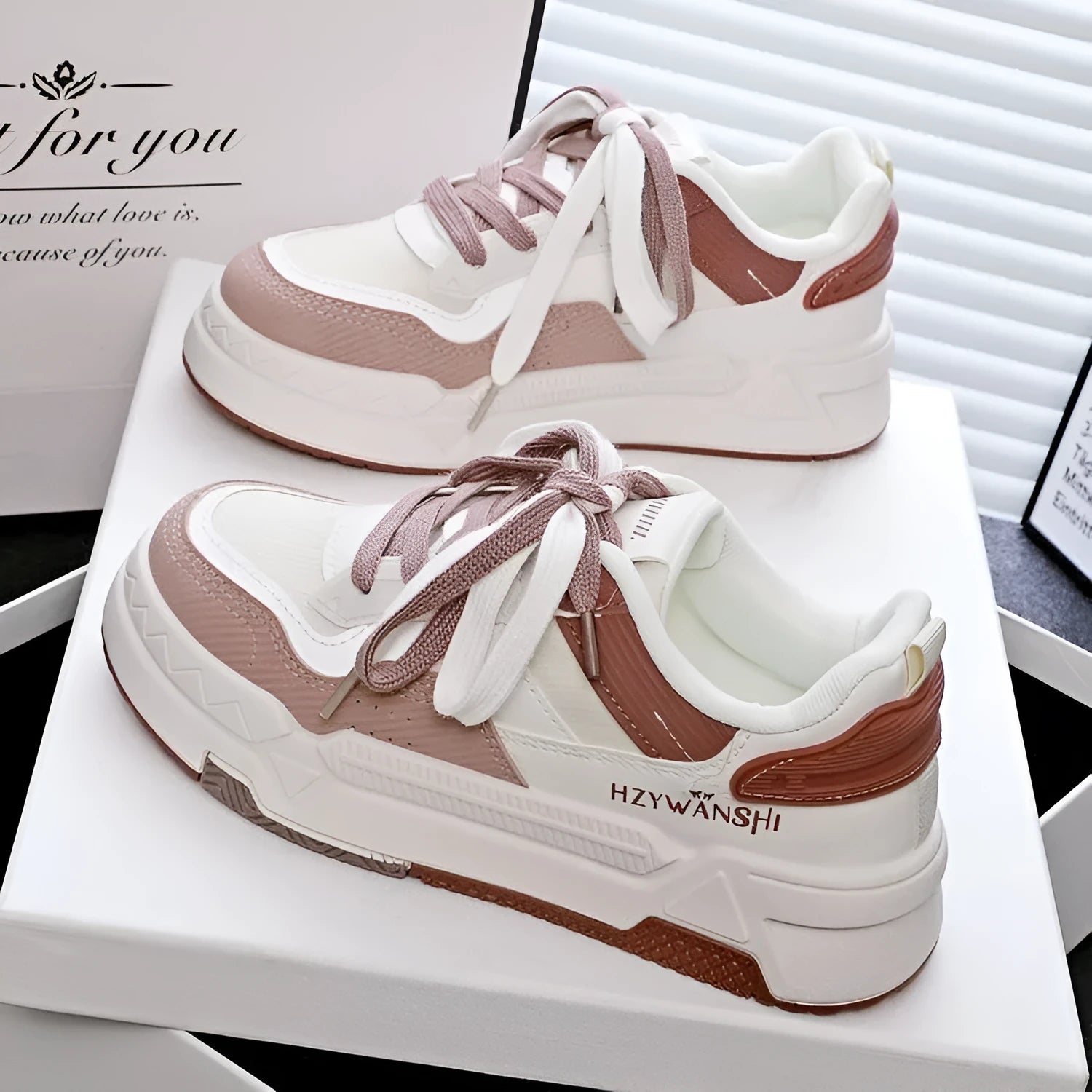 Beige children's platform trainers with cross shoulder straps and white laces on a 3cm thick rubber sole.