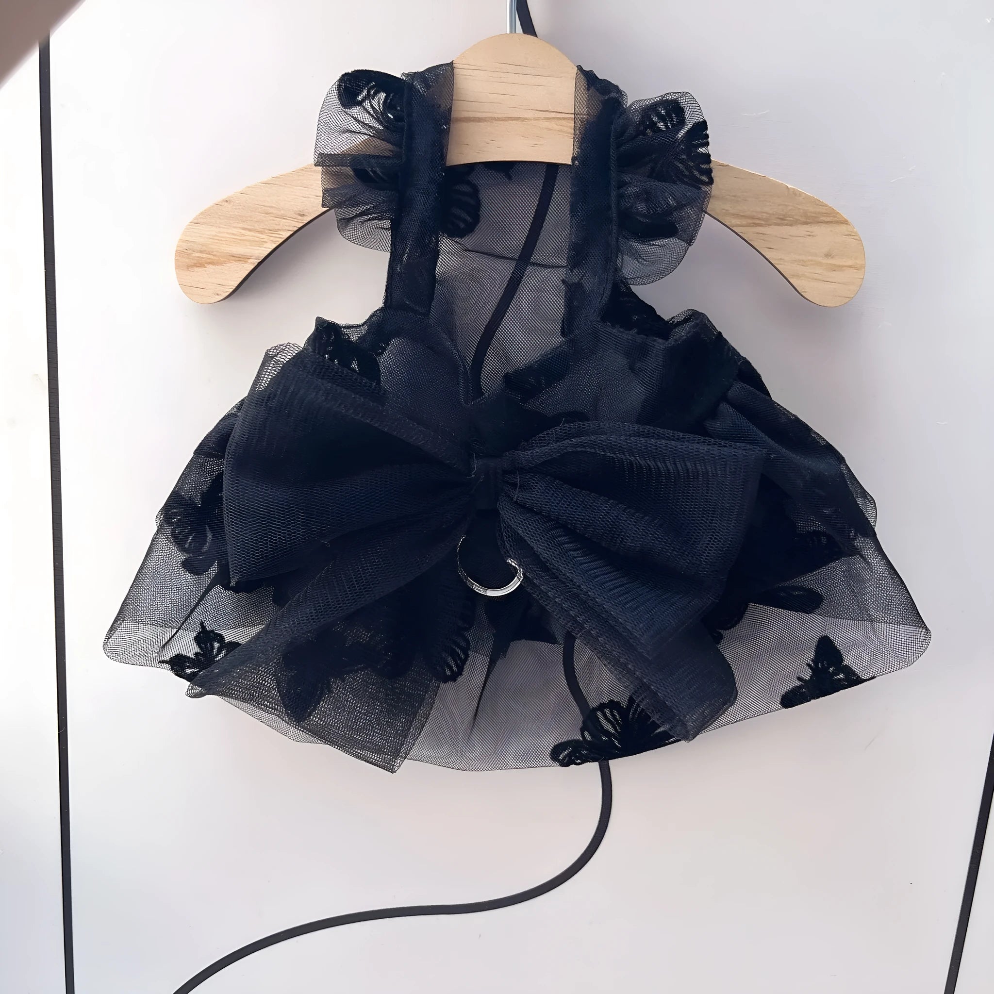 Black layered tulle princess skirt on a small dog, showing the full skirt silhouette and secure fit.