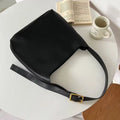 Women's soft PU shoulder bag with tassel detail in black and brown colour options