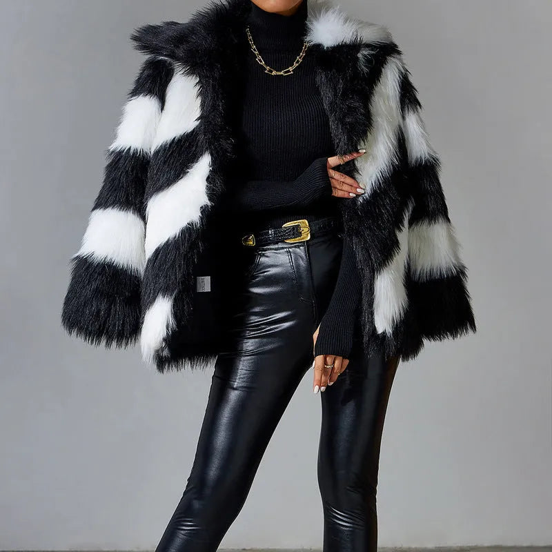 A picture colour faux fur coat with a contrast lapel and a textured fur collar, shown on a hanger.