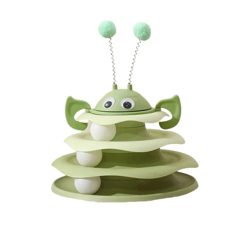 Cat toy tower with rotating bee toy and three-layer trackball in green plastic, placed on a wooden floor