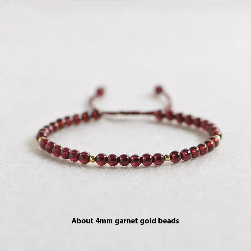 Hand-woven garnet red rope bracelet made from flexible wire, showing national tide style.