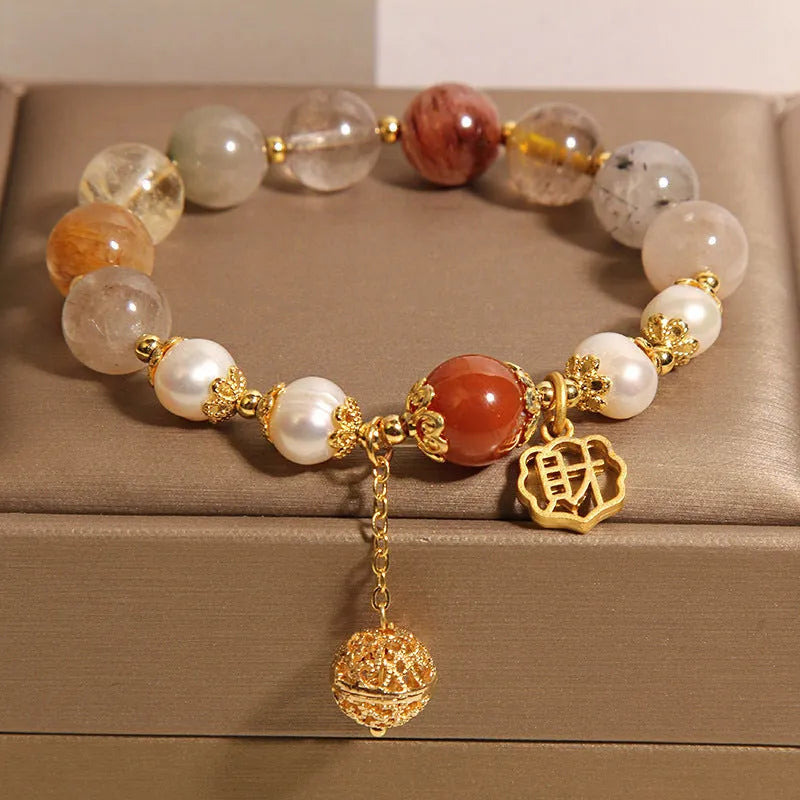 Women's Japanese-style crystal bracelet with pearls and Chinese 'Cai' character charm.