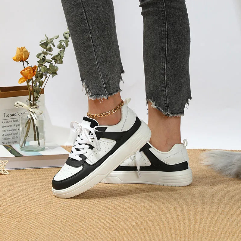 Pair of solid colour low heel lace-up board shoes with artificial PU upper and rubber sole