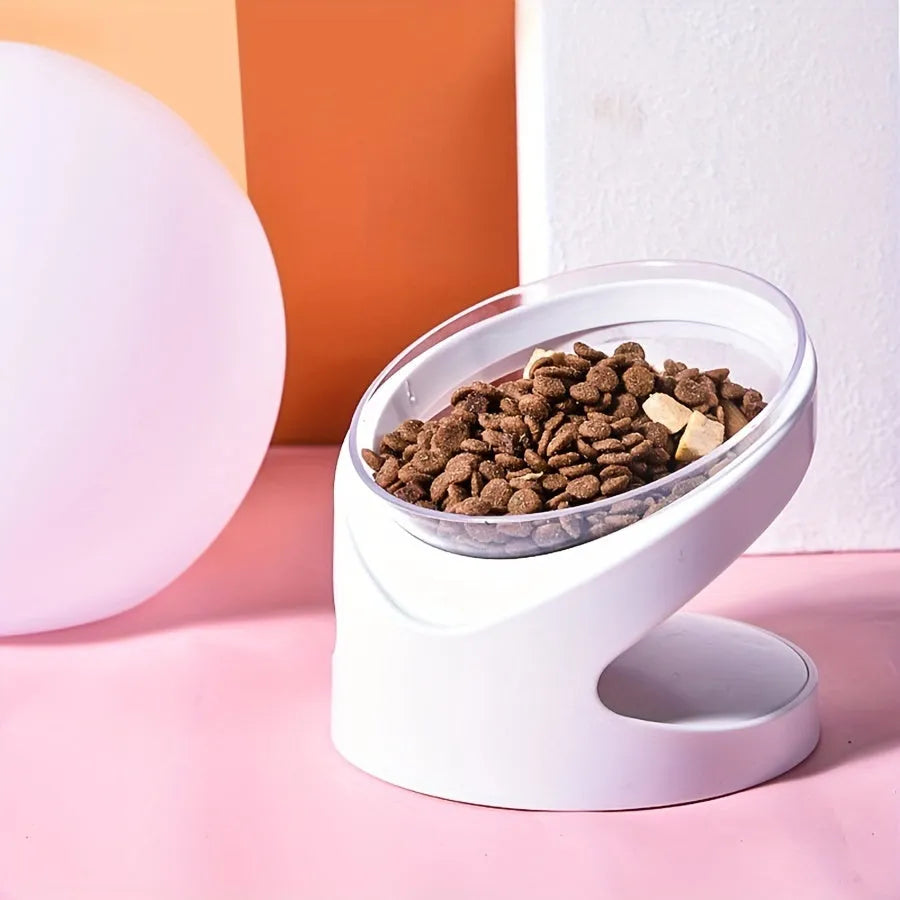 White elevated clear plastic cat food bowl with a tilted feeding surface for neck support.