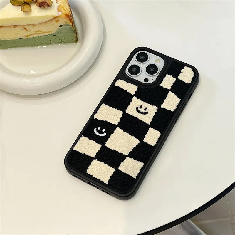 Black and white chessboard TPU phone case for iPhone with precise cutouts on a white background
