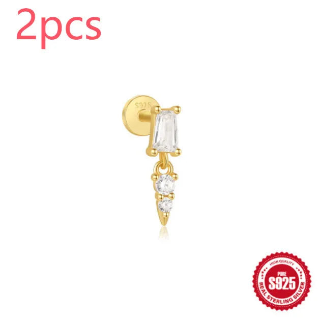 S925 sterling silver ear stud with XINGX inlaid tassel design in a gold colour.