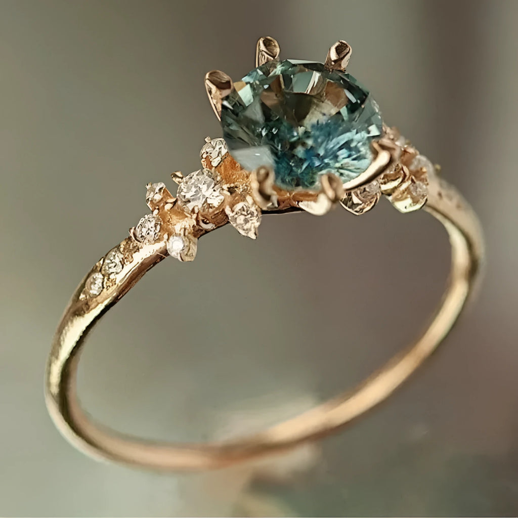 Gold coloured geometric ring with claw-set zircon stones and a chamfered square design.
