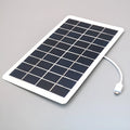 Black solar panel mobile phone charger with USB port and textured PET surface