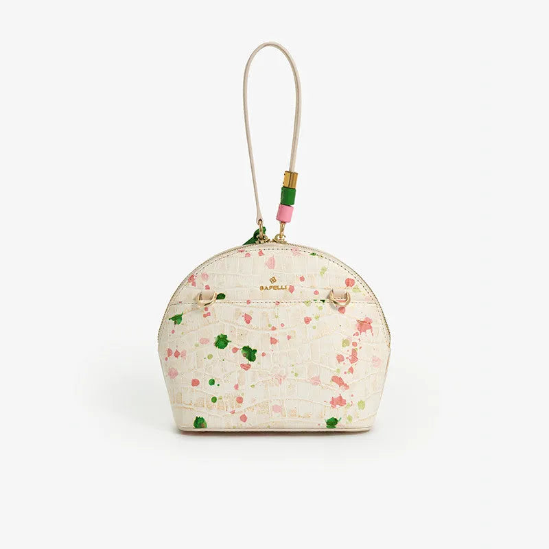 Women's genuine cow leather shell shape tassel handbag in Gypsophila colour with zipper closure