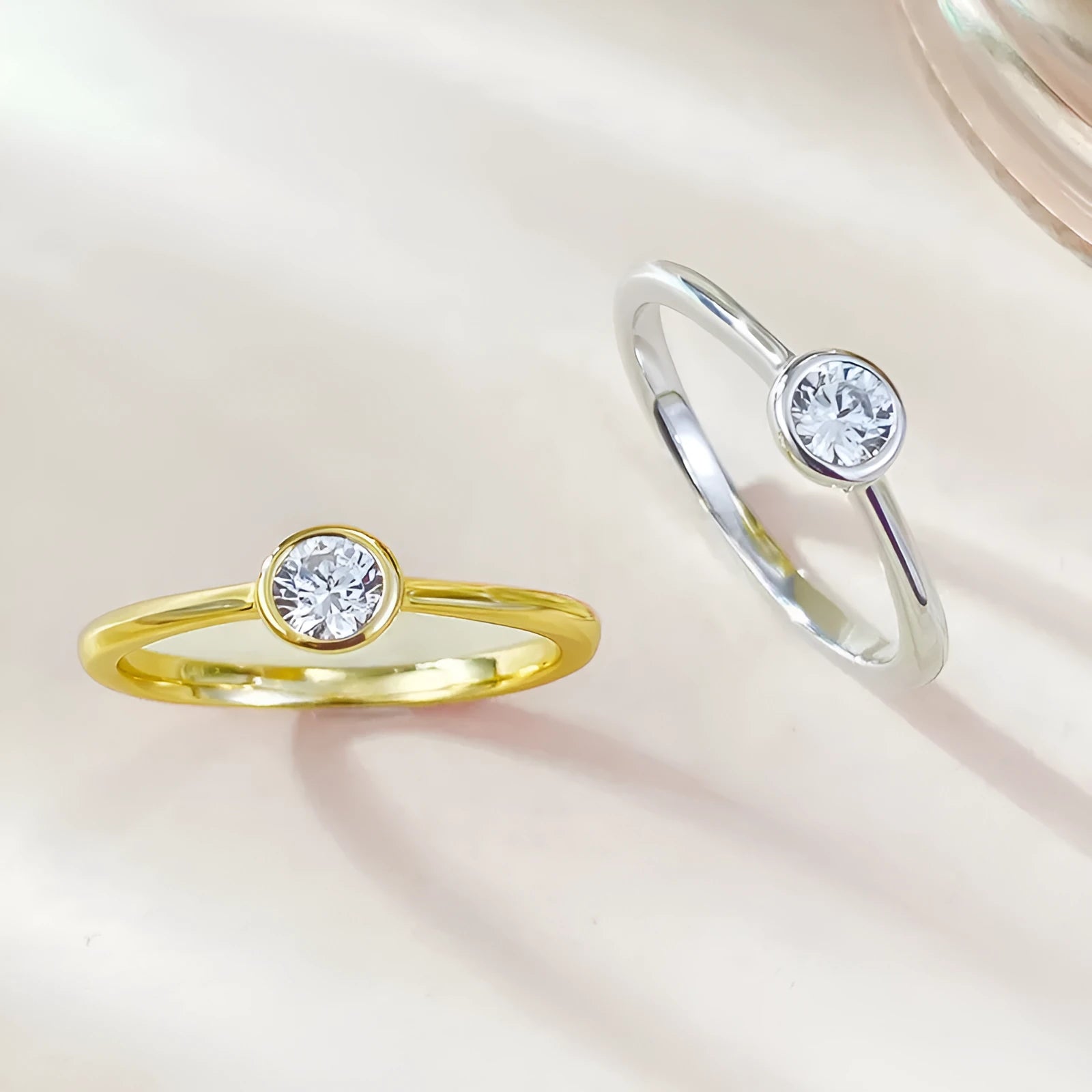 Minimalist crown-shaped silver ring in gold or platinum finish, shown in a simple setting.