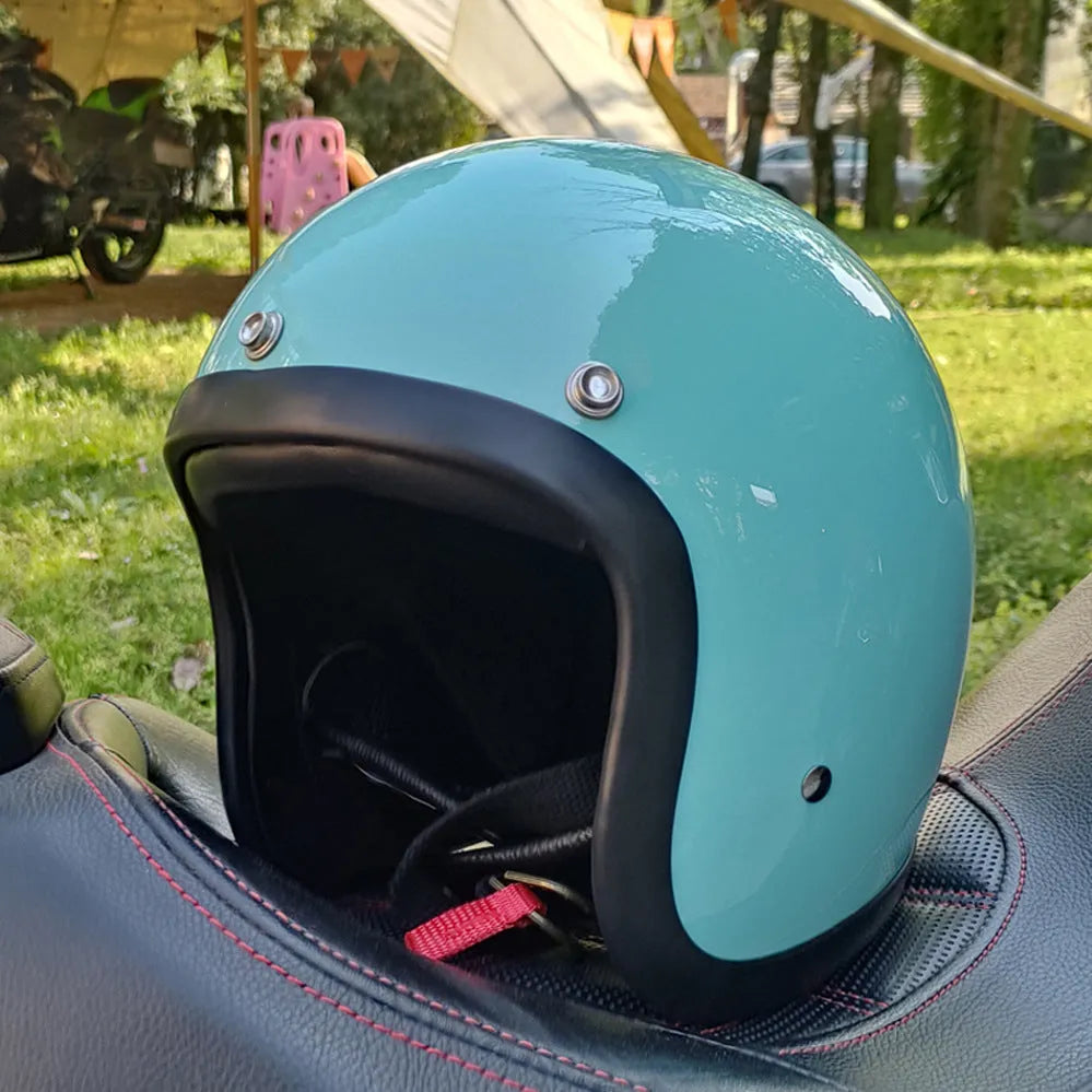 Retro-style open-face motorcycle half helmet in cement grey with a glossy FRP shell and quick-release chin strap.