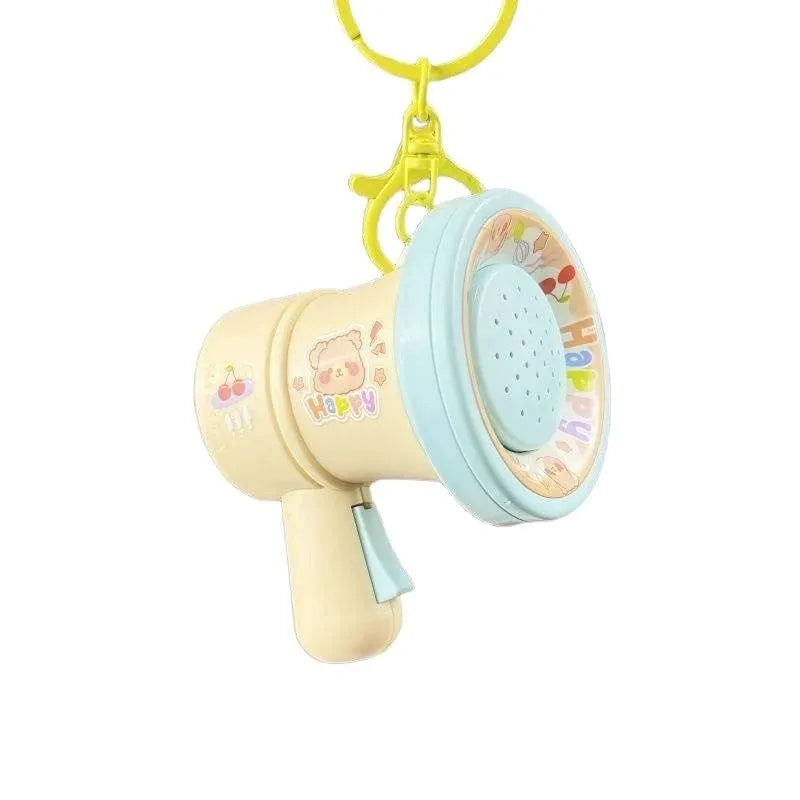 Green and yellow plastic cartoon small horn keychain ornament on a key ring.