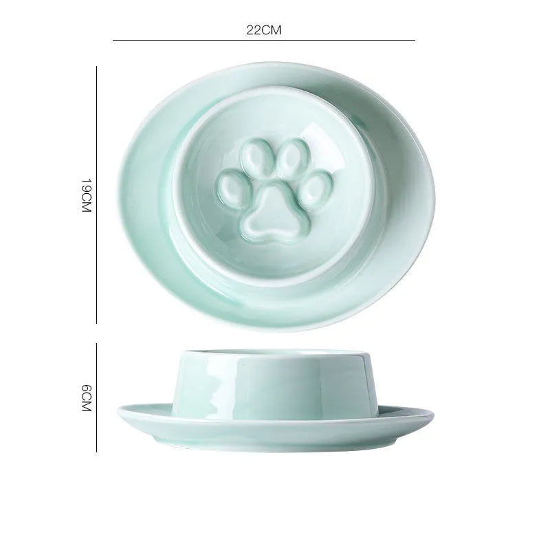 Green ceramic anti-choking slow food bowl for cats and dogs on a flat surface.