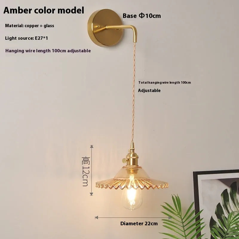 Retro brass lotus wall lamp with adjustable copper wire and white glass shade mounted on a wall.