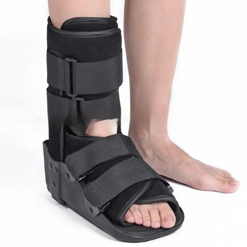 Grey Achilles tendon rehabilitation boot with fixed support and walking shoe sole.