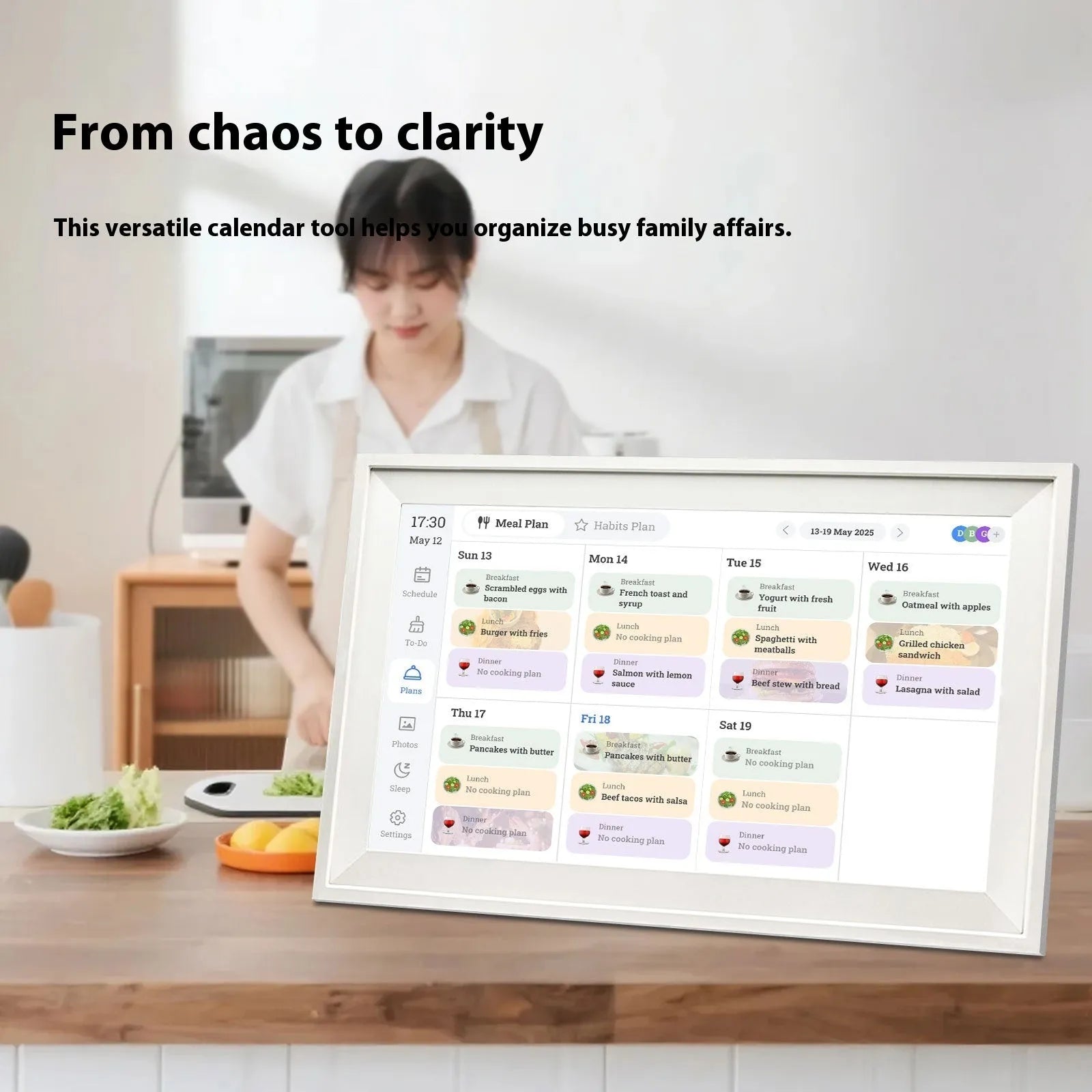 White 15.6 inch smart digital photo frame with Full HD screen on a wooden desk.