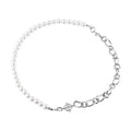 White geometric asymmetric acrylic pendant necklace on a twisted metal chain, shown against a neutral background.