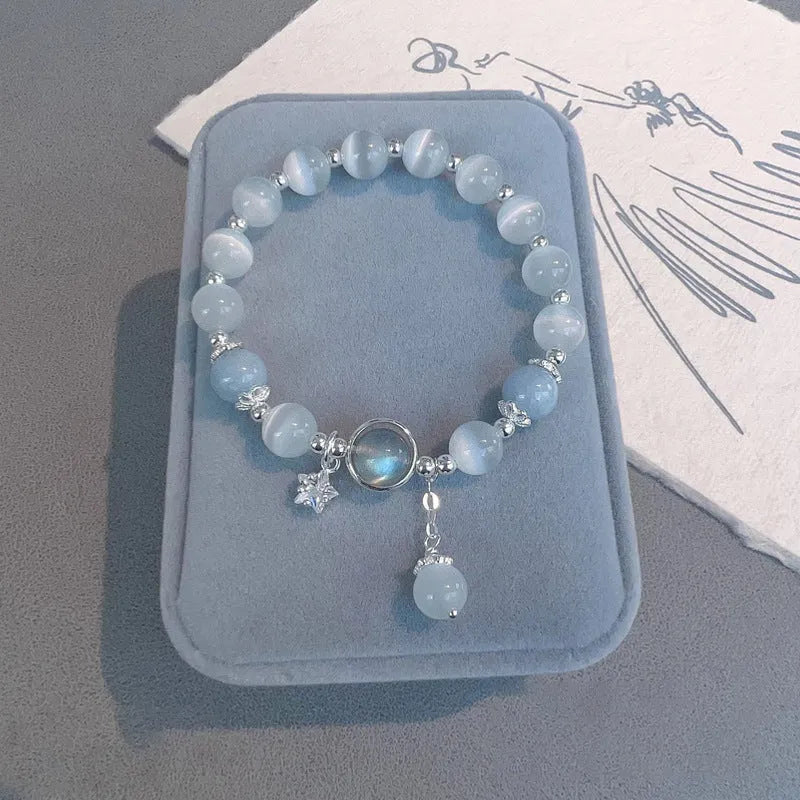 Close-up of electroplated opal cat's eye beaded bracelet for women with diamond-shaped charm