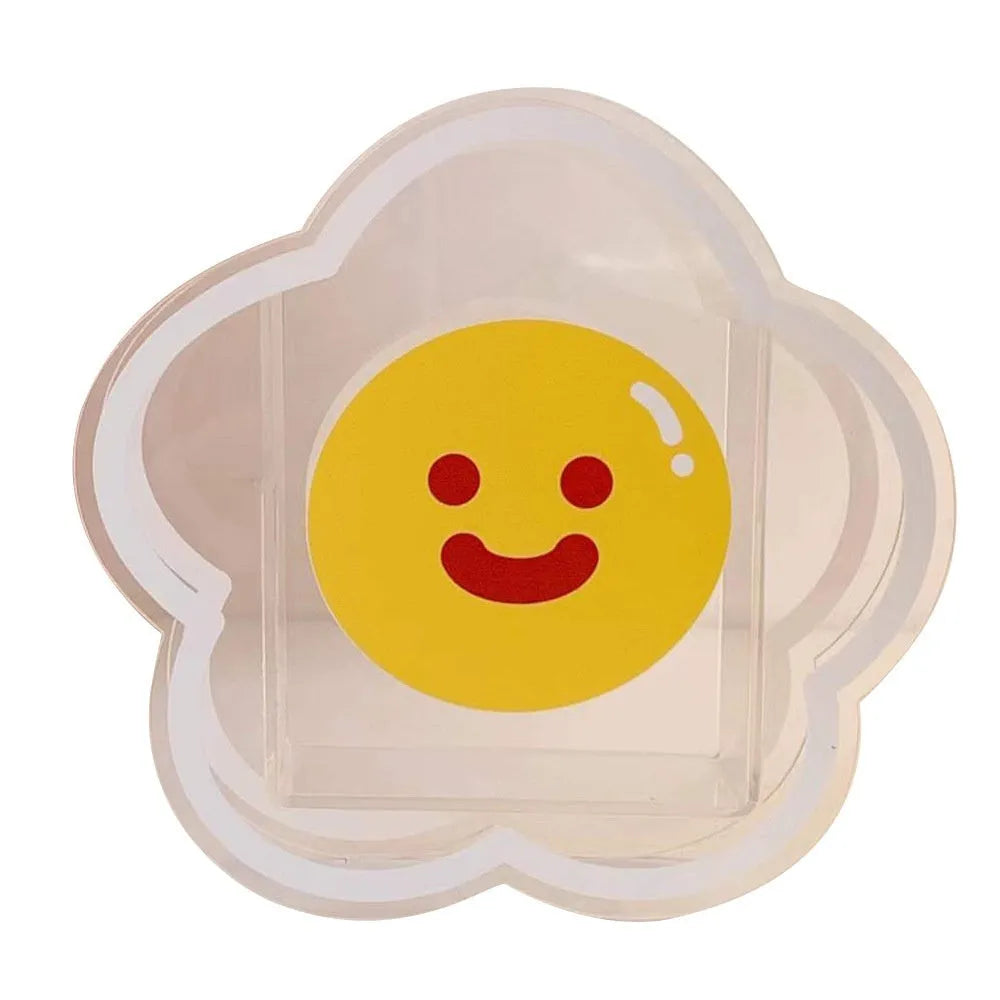Clear square acrylic storage box with a colourful printed lid featuring a cute design, shown holding pens and stationery.