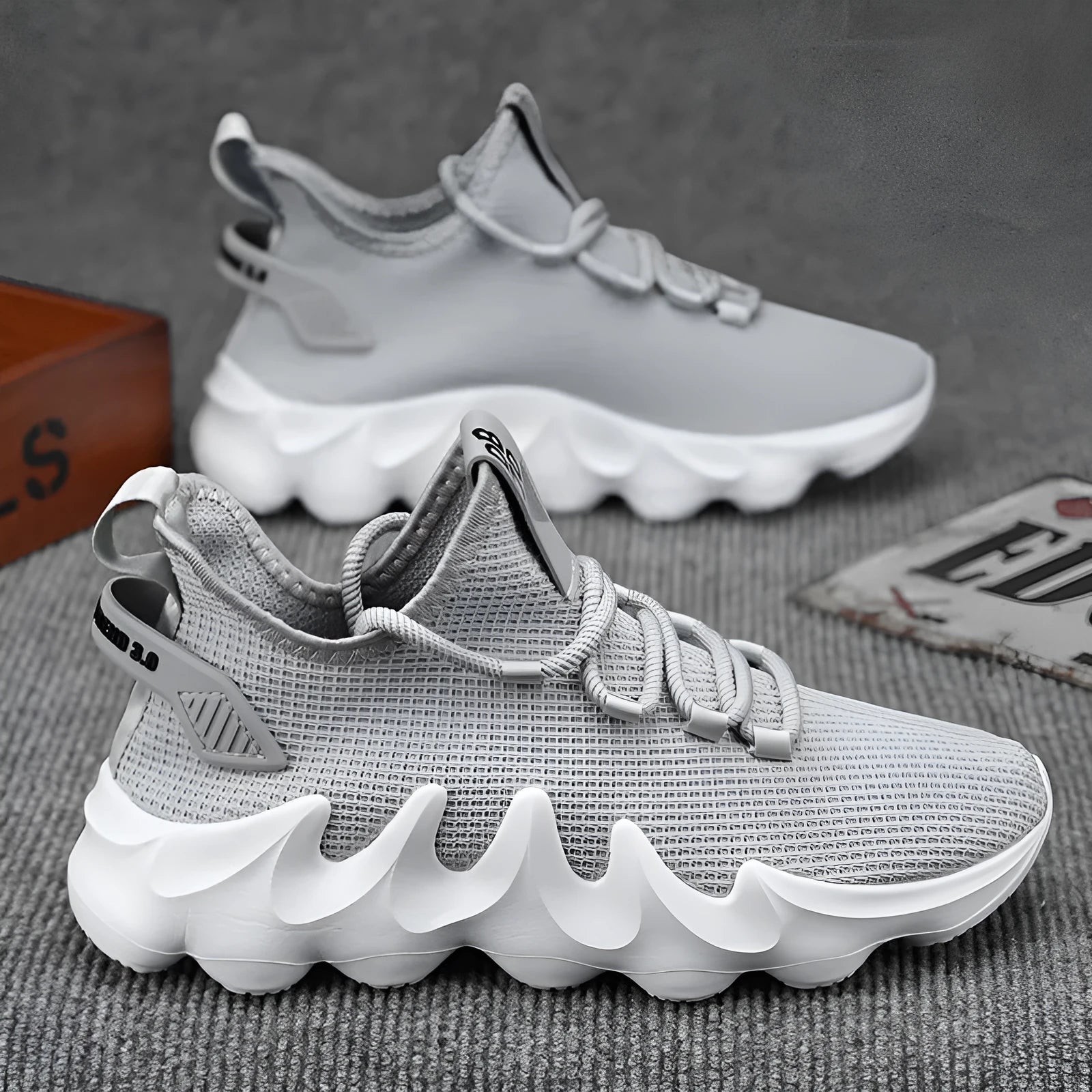 Men's black low-top sock-like sports shoes with a lace-up front and wear-resistant sole on a white background.