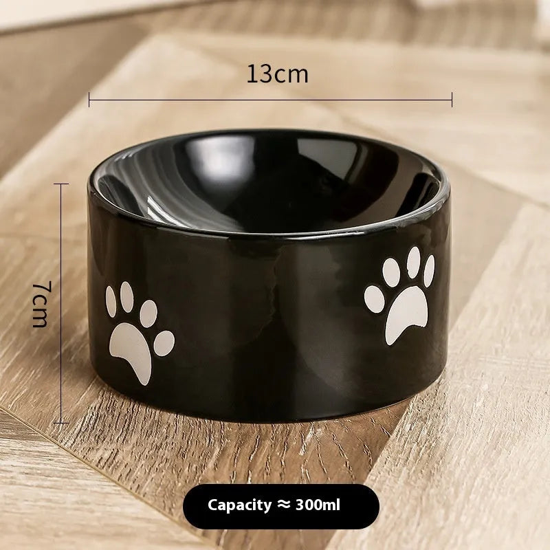 Ceramic cat bowl with cat paw design in black, showing oblique mouth style.