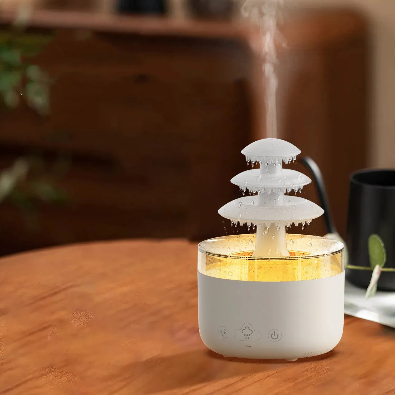 White Cloud Rain air humidifier and essential oil diffuser with colourful LED light on a table.
