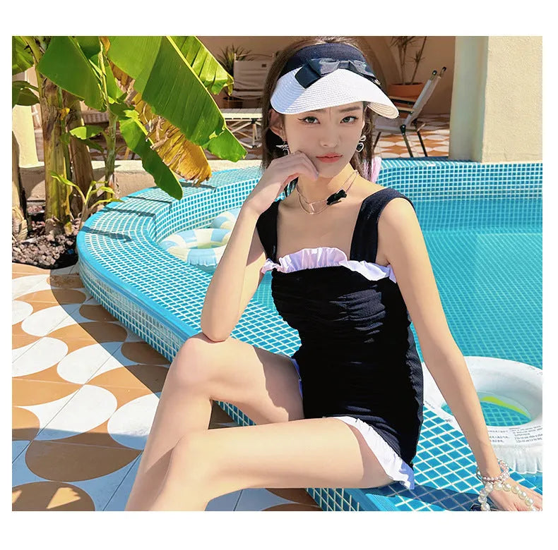 Women's one-piece swimsuit with suspender straps in solid colour options