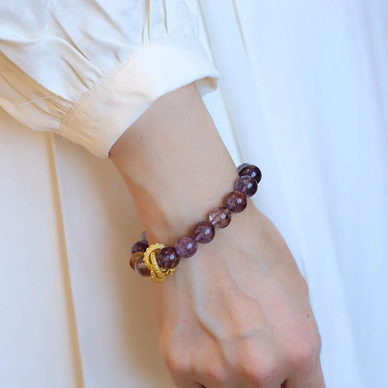 Purple cornucopia crystal bracelet with 10mm animal zodiac beads on wrist