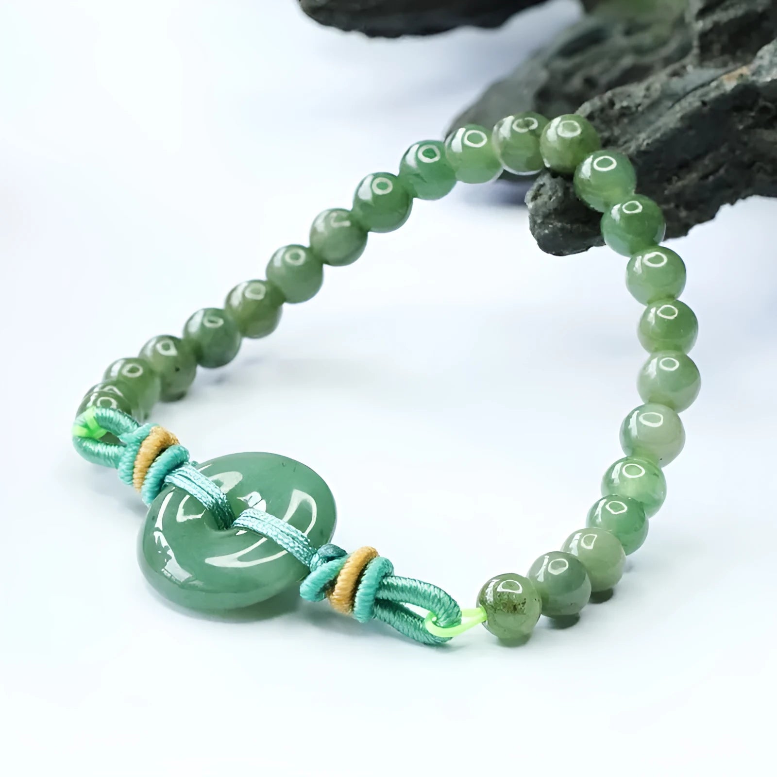 Oil green jade bracelet with safety buckle closure showing star-shaped 6mm beads