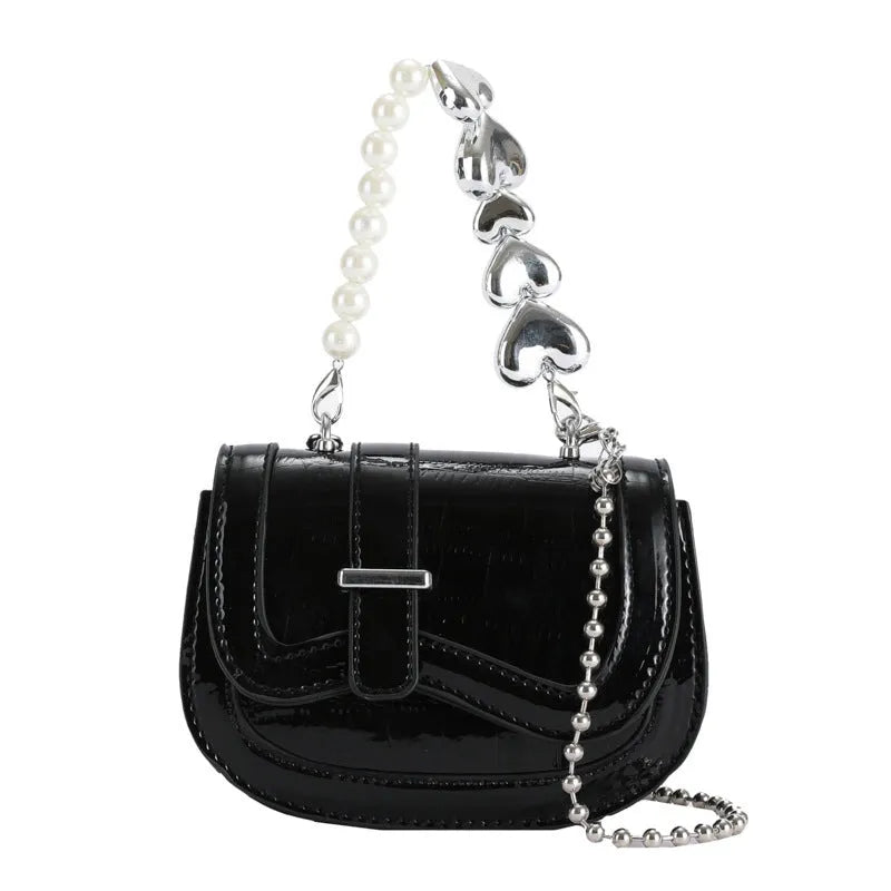 Women's silver mini crossbody bag with a square shape and a single shoulder strap.
