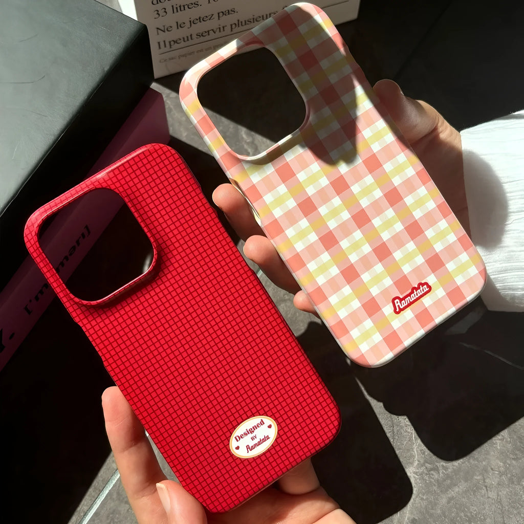 Red and orange plaid iPhone 15 Pro Max phone case with glossy and frosted finish options.
