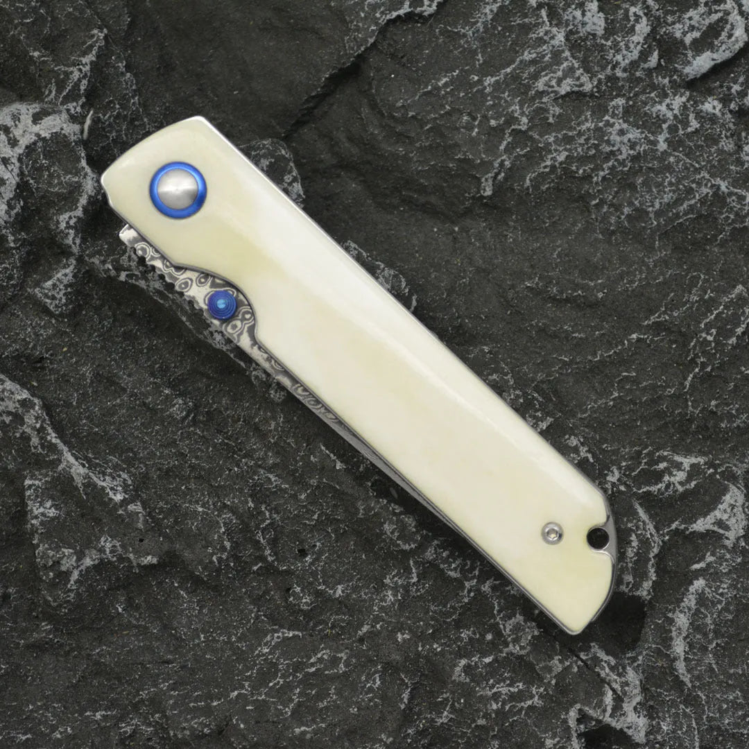 Damascus steel folding knife with black finish and ox bone handle, blade open showing 8.5cm cutting edge