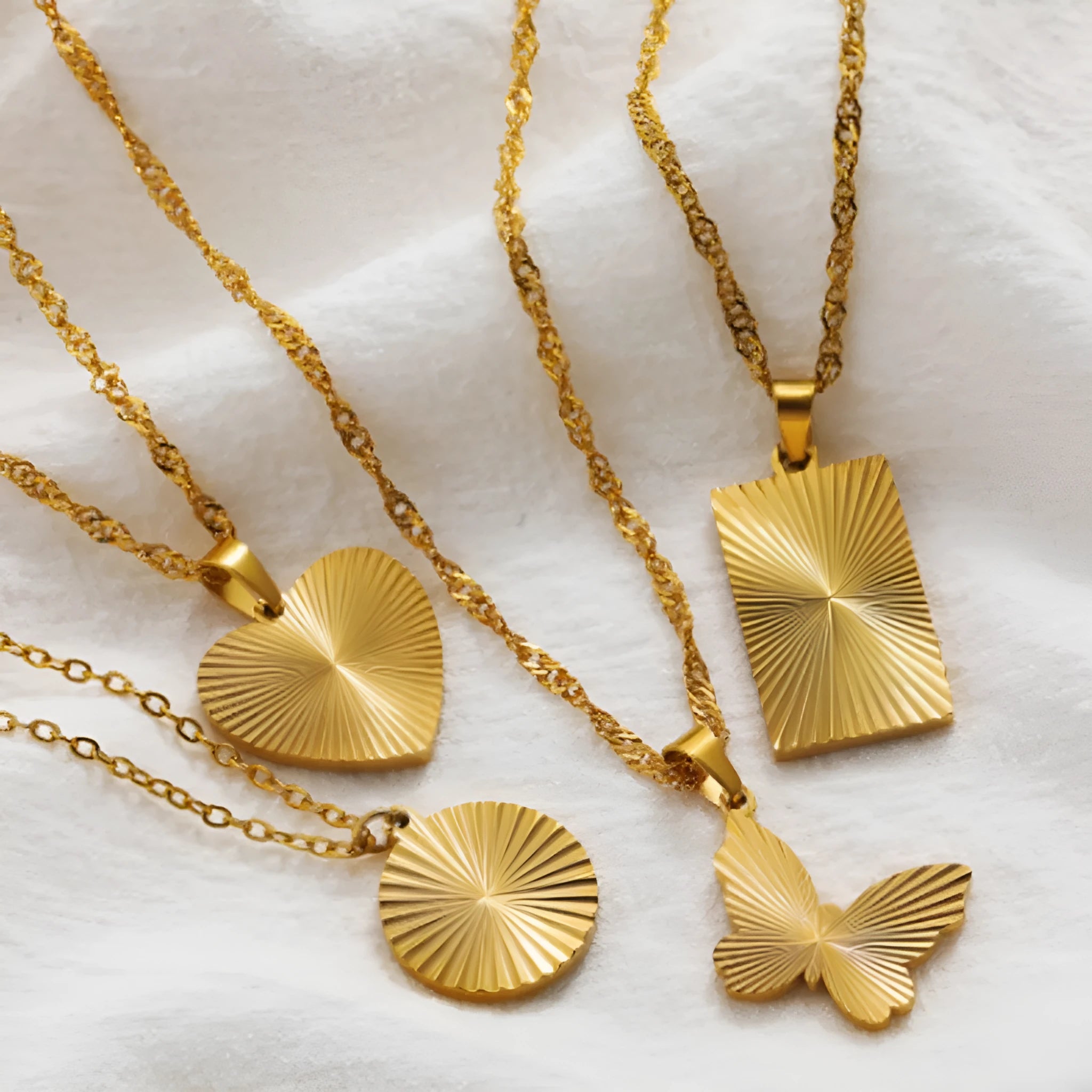 Gold pleated necklace with butterfly design pendant on water wave chain