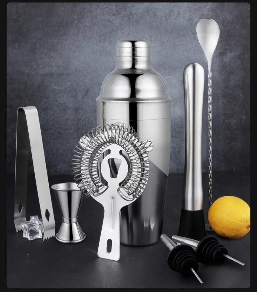23-piece stainless steel cocktail set with drink mixers on a bar