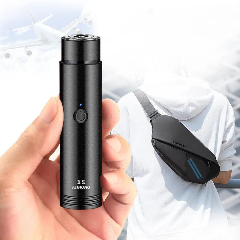 Compact portable electric shaver in black with USB charging cable.